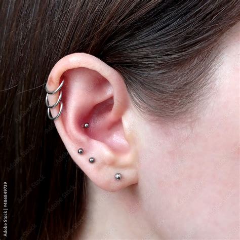 ear piercings photos.Helix piercing.Ear rings Stock Photo | Adobe Stock