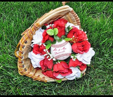 a baseball and roses arrangement in a basket on the grass