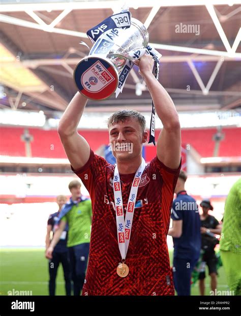 Carlisle United's Owen Moxon celebrates with the trophy after being ...