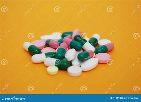 Colored Pills, Tablets and Capsules, Pharmacy and Medicine, on Yellow ...