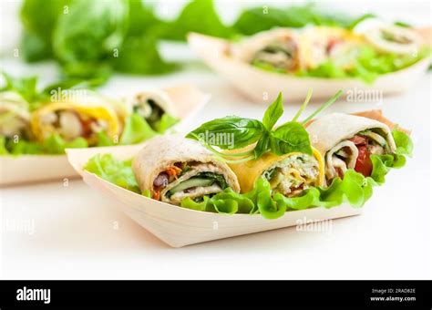 Assortment of fresh tortilla wraps with chicken, cheese and vegetables ...