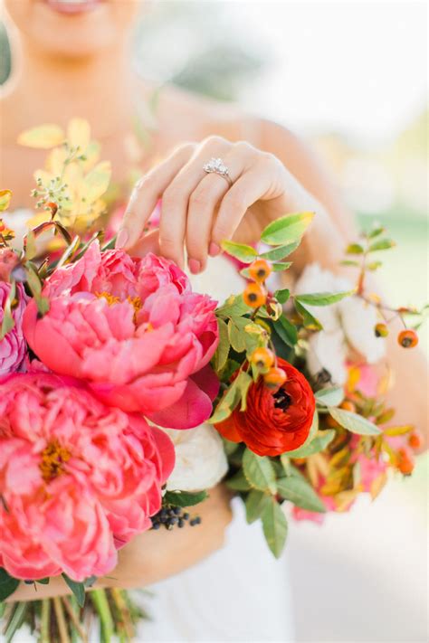 Lush bridal bouquet of coral peonies, rose hip, ranunculus and privet berry by Layers of Lovely ...