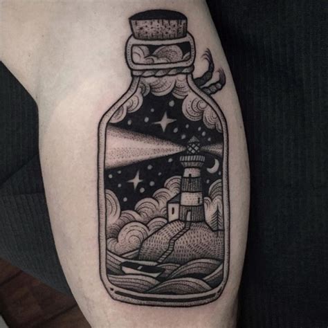 3D interesting painted black ink bottle tattoo on arm with night lighthouse - Tattooimages.biz