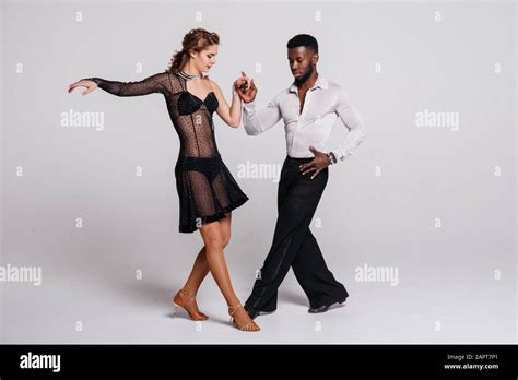 Couple dancers posing over white background. Dance school concept Stock Photo - Alamy