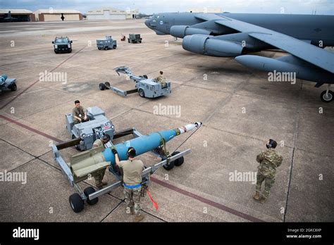 A weapons load crew from the 2nd Aircraft Maintenance Squadron transport a GBU-10 munition to be ...