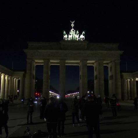 As a show of solidarity, Berlin's Brandenburg Gate was lit up in colors ...