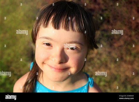 Portrait of little girl smiling on the grass background Stock Photo - Alamy