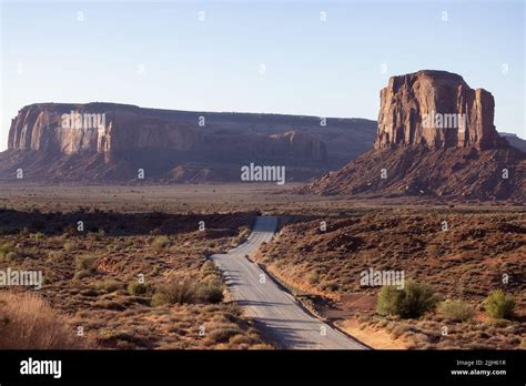 Dirt Road in a Desert Rocky Mountain American Landscape. Morning Sunny Sunrise Sky. Oljato ...