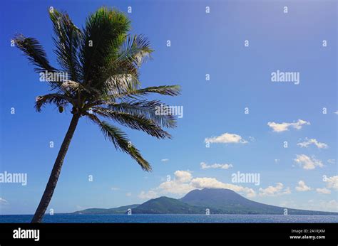 Day view of the Nevis Peak volcano across the water from St Kitts Stock Photo - Alamy