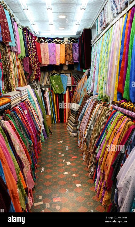 A typical small textile shop in the traditional souq at the heart of ...