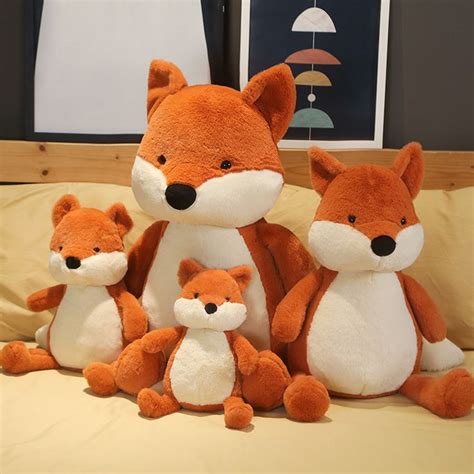 three stuffed animals sitting on top of a bed next to each other in a room