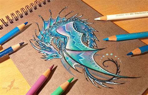 some colored pencils are laying on top of a notebook with an image of a sea horse