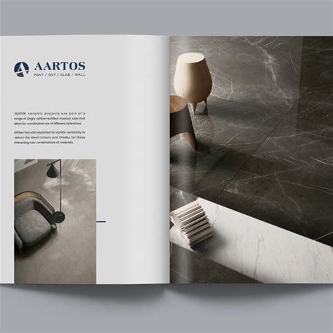 an open book showing the inside pages of a chair and table in grey marble with black accents