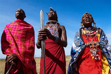 Group of Massai men and women singing and dancing, Masai Mara National ...