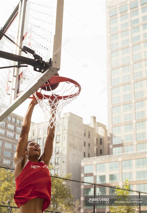 Man dunking basketball on court — fitness, Weekend Activities - Stock Photo | #199734988