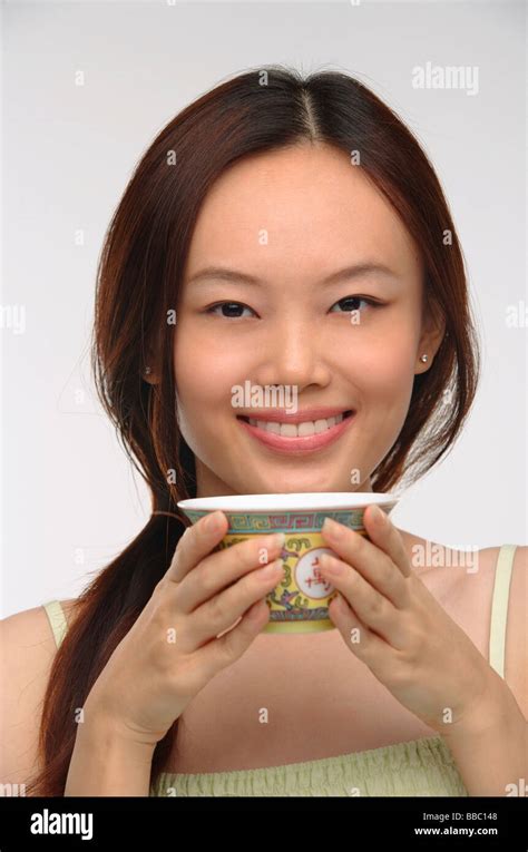 Young woman with traditional tea cup smiling at camera Stock Photo - Alamy