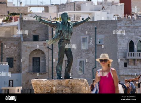 View of the Domenico Modugno bronze statue in Polignano a mare Stock ...