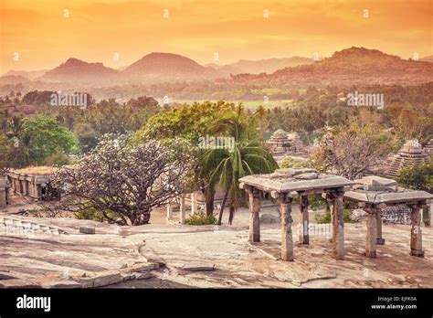 Ancient ruins on Hemakuta hill at orange sunset sky in Hampi, Karnataka, India Stock Photo - Alamy