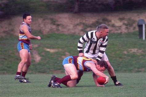 Australian Rules Football - He's Down Photograph by Jerry Griffin - Pixels