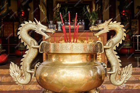 Premium Photo | A gold dragon statue is placed in front of a temple.