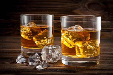 Premium Photo | Two glasses with ice and whiskey