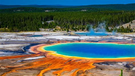 Yet another Yellowstone tourist ignores safety warnings and struts across Grand Prismatic