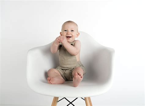 Baby Sitting on White Chair · Free Stock Photo