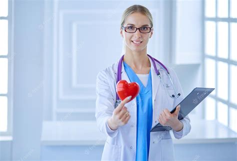 Premium Photo | Female doctor with the stethoscope holding heart