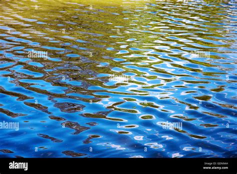 Shimmering water surface reflection Stock Photo - Alamy