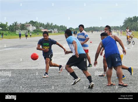 FUNAFUTI, Tuvalu - Young men play football on the international airport's runway in Funafuti ...