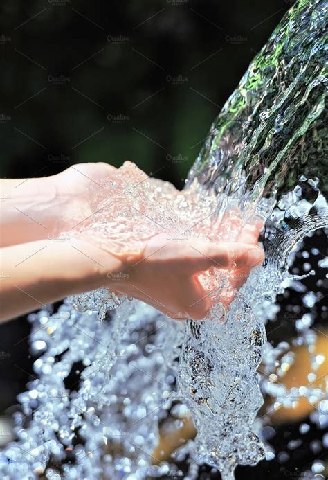 Woman's hands with water splash containing water, hand, and purity ...