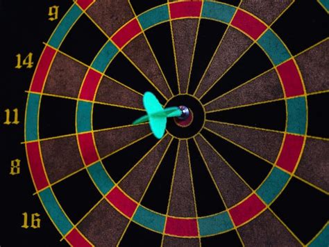 Premium Photo | Dart game and an arrow right in the middle