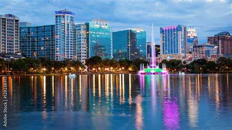 Orlando, Florida City Skyline on Lake Eola as Night Falls (logos ...