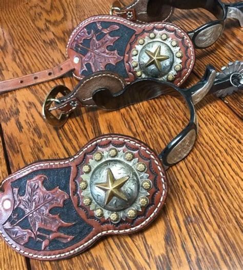 two western style belts on a wooden table