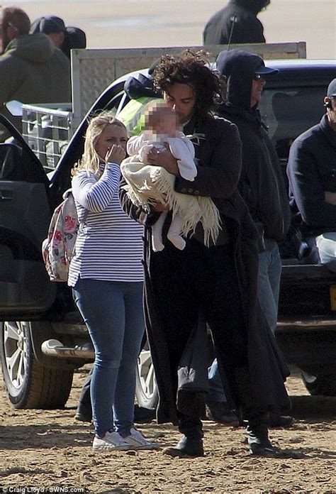 Aidan Turner cradles a baby during Poldark filming break | Daily Mail Online