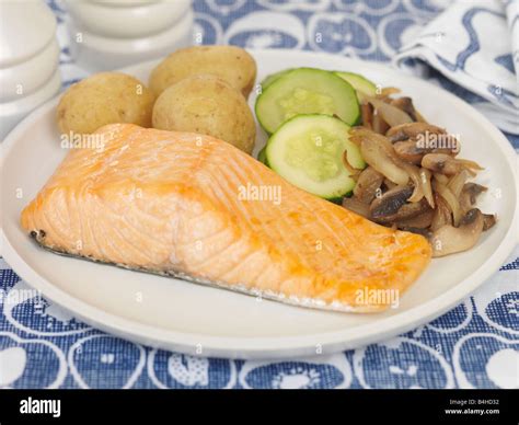 Salmon Steak with New Potatoes Stock Photo - Alamy