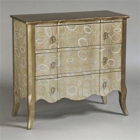 an ornate gold and white chest of drawers