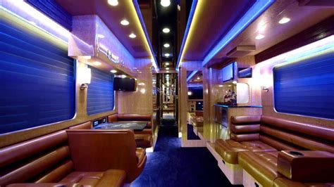 the inside of a train car with leather seats and tables on each side is ...