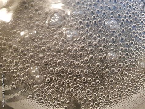 bubbles in boiling water on stove background Stock Photo | Adobe Stock