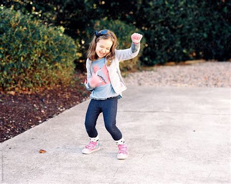 "Cute Young Girl Dancing Outside" by Stocksy Contributor "Jakob Lagerstedt" - Stocksy