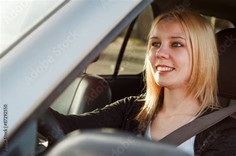 Young blonde student teenage girl driving a silver car Stock Photo ...