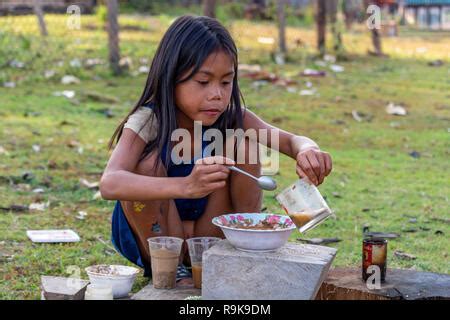 Thakhek, Laos - April 19 2018: Local kids playing to eat a meal they ...