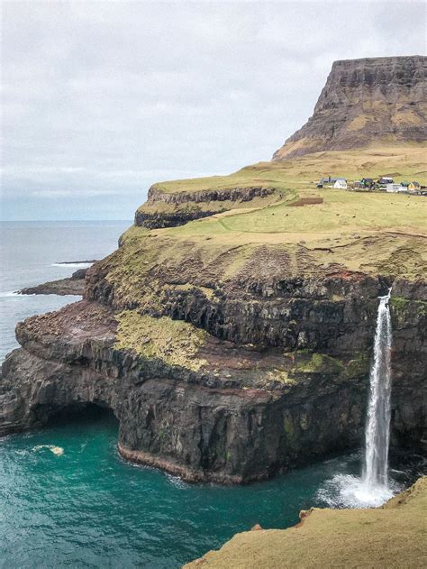 Visit the Fairytale Faroe Islands Waterfall: Múlafossur Waterfall in Gásadalur - Compass + Twine