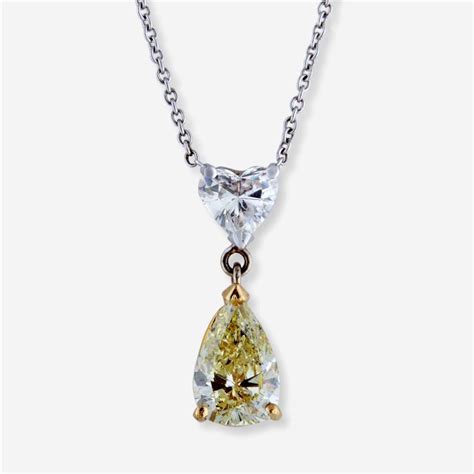 Sold Price: A fancy light yellow diamond, colorless diamond and fourteen karat bi-color gold ...