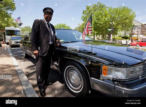 African-American limousine driver standing next to car - Washington, DC USA Stock Photo - Alamy