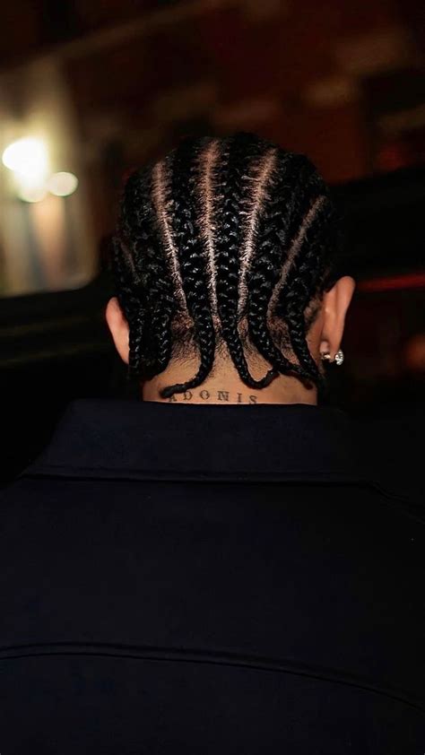 the back of a woman's head with braids on her hair