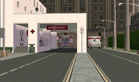 two ambulances are parked at the entrance to an emergency station in front of tall buildings