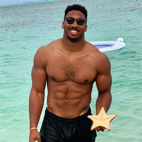 a man standing in the ocean holding a starfish