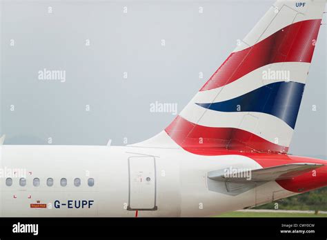 A close up of the British Airways logo on the tail fin of a passenger ...