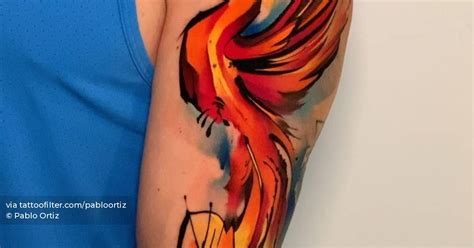 Watercolor style phoenix tattoo located on the arm.